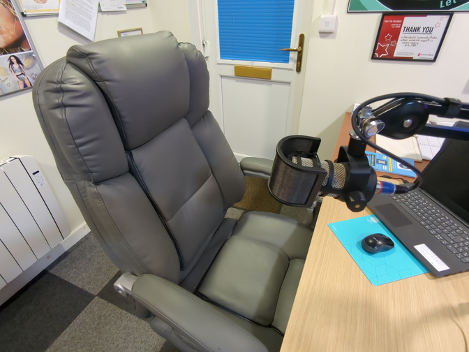 Desk chair in front of microphone and laptop